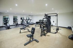 a gym with several tread machines in a room at Perfect Luxury @ Henrietta’s Residence in Accra