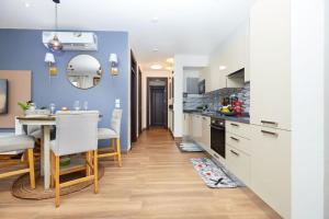 a kitchen and dining room with a table and chairs at Perfect Luxury @ Henrietta’s Residence in Accra