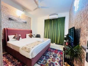 a bedroom with a bed and a television in a room at Panaromic Perch With Swimming Pool in Lucknow