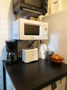 a kitchen counter with a microwave and a coffee maker at Valencia Well Located Shared Apartment in Valencia