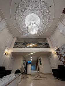 a ceiling with a large chandelier in a building at Panaromic Perch With Swimming Pool in Lucknow