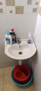 a bathroom sink with a red bowl under it at Luca Homes Studio Apartment In Bamburi Mombasa in Mombasa