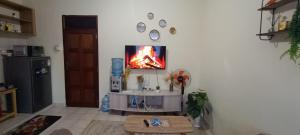 a living room with a tv on a wall at Luca Homes Studio Apartment In Bamburi Mombasa in Mombasa