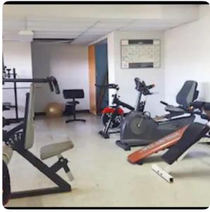 a gym with several exercise bikes in a room at Paradise Palms in San Juan