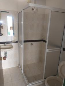 a bathroom with a shower and a toilet and a sink at Hotel PARAMO LIDERATO in Paramo