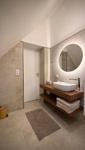 a bathroom with a sink and a mirror at Maison au cœur de la forêt 
