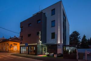 wysoki biały budynek przed budynkiem w obiekcie Hotel National w Zagrzebiu