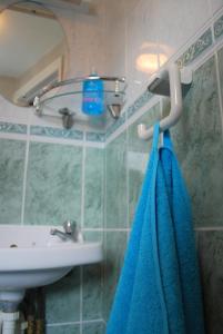 a bathroom with a sink and a blue towel at Clift Guest House in Bristol