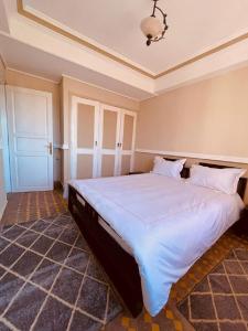 a bedroom with a large white bed in a room at Villa Dune Rouge de la Siesta in Mohammedia +12 photos