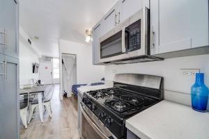 a kitchen with a stove and a microwave at Ocean Drive Beach Fun, w/2 Queen Beds South Beach in Miami Beach