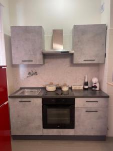 a kitchen with a sink and a counter top at Suite Incentrum - Selfie room in Alba