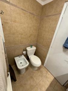 a small bathroom with a toilet and a bidet at Las Ranitas in Parque del Plata +20 photos