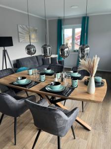 a dining room table with chairs and a dining room at Luxurious apartment with mountain views in Prien am Chiemsee