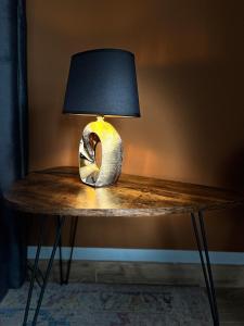 a lamp sitting on a table with a lamp on it at Harmony Hideaways I 90qm I Bergblick I 3 Balkone I seenah in Prien am Chiemsee +18 photos