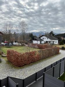 a hedge in a yard with a house in the background at Luxurious apartment with mountain views in Prien am Chiemsee