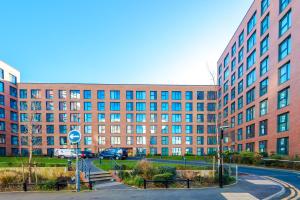 a large brick building with a street in front of it at Axium Suite- Modern 2 bed in Birmingham City Centre- Perfect for Business, Family and Leisure Stays in Birmingham