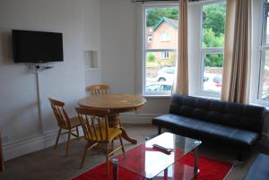 a living room with a couch and a table at Clift Guest House in Bristol