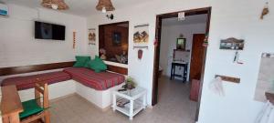 a room with a bed and a table in a room at Balcon Al Paradiso in Santa Rosa de Calamuchita
