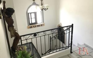 a stairway with a statue on a railing and a window at Hospedaje Aldana - Casa LA VISTA en zona verde in Tuxpan de Rodríguez Cano