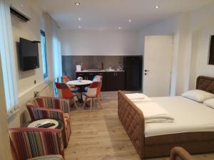 a bedroom with a bed and a table and chairs at UB Prenociste in Vranjska Banja