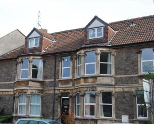 an old brick house with a brown roof at Clift Guest House in Bristol