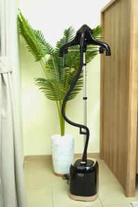 a black lamp sitting next to a plant at Pure Sand - Luxury Hostel JBR Dubai in Dubai