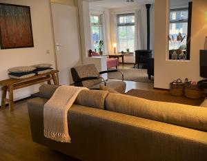a living room with a couch and a table at De Compaenenhorst in IJhorst