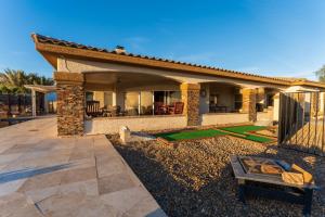 a home with a patio with a fence and a yard at 9 Hole Mini-golf With Shade Cornhole Pingpong Amazing Lake Views, PalmTrees in Lake Havasu City