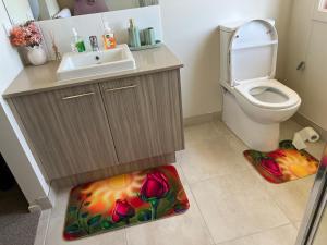 a bathroom with a sink and a toilet at Paradise pavilion hide away in Cranbourne