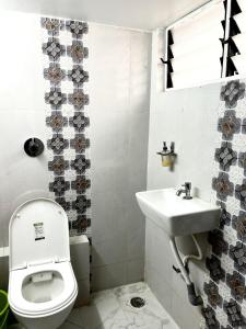 a bathroom with a toilet and a sink at Varsha's Villa A Luxurious Stay. in Nagpur