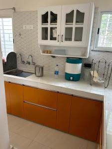 a kitchen with orange cabinets and a sink at Varsha's Villa A Luxurious Stay. in Nagpur