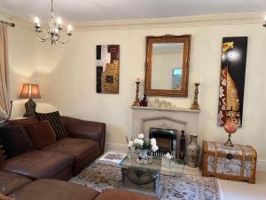 a living room with a couch and a fireplace at Coral Gables in Northampton
