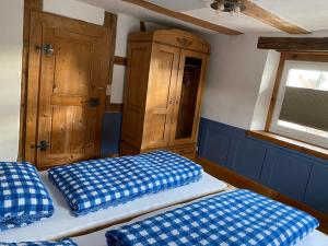 a bedroom with two beds and a cabinet and a window at Schwarzwald - Ferienhaus in Tannheim in Villingen-Schwenningen