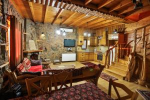 a large living room with a stone wall at Shtepia Tradites Gjinar in Elbasan
