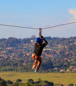 a person is hanging on a zip line at Masaka Cultural Resort in Masaka