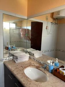 a bathroom counter with a sink and a mirror at Apartamento paysandu in Paysandú