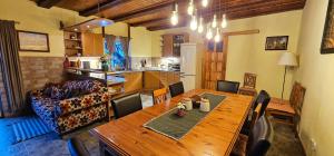 a living room with a wooden table and a couch at Srub pod Tetřevím vrchem in Dolni Dvur