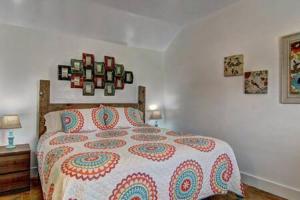 a bedroom with a bed with a colorful comforter at Spanish Village Siesta Villa in Port Aransas