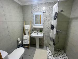 a bathroom with a sink and a toilet and a mirror at RIAD LALLA ZINEB in Rabat +51 photos