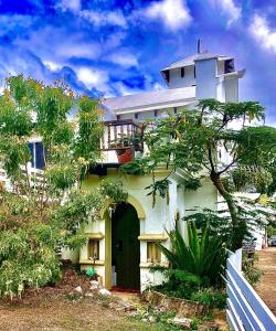a large white house with a balcony on top of it at Estate Lowry Hill in Christiansted