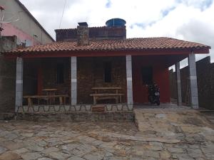 a house with a motorcycle parked in front of it at Chalé Triunfo in Triunfo