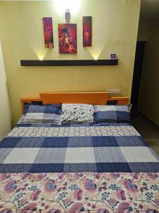 a bed with two pillows on it in a room at Joys Stay in Trichūr