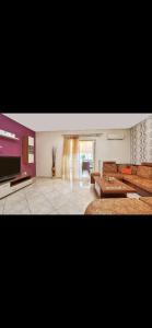 a living room with a couch and a table at Cozy apartment next to the port! in Piraeus