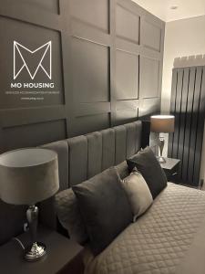 a bedroom with a couch with a no housing sign on the wall at DULEX ROOMS in Scunthorpe