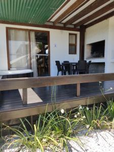 a porch of a house with chairs and a table at Serena del Lago in La Paloma