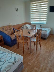 a living room with a table and chairs and a couch at Hostel Polon in Pułtusk