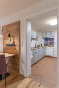 a kitchen with a door open to a dining room at Modernes Apartment in altem Bauernhaus in Aflenz Kurort