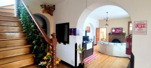 a hallway with a staircase in a house at Minka Hostel in Quito