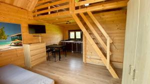 a room with a kitchen and a desk with a table at "OhMazury" ogród i winnica in Giżycko