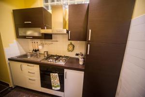 a kitchen with a black refrigerator and a sink at Borgo Boutique Home near Rome in Nettuno